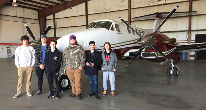 Juniors Saydie Kosmuch, Dale McConnell, Tristan Zinc and sophomores Josh Lake and Angelo Cresta tour a Beech King Air while learning about aircraft inspections.